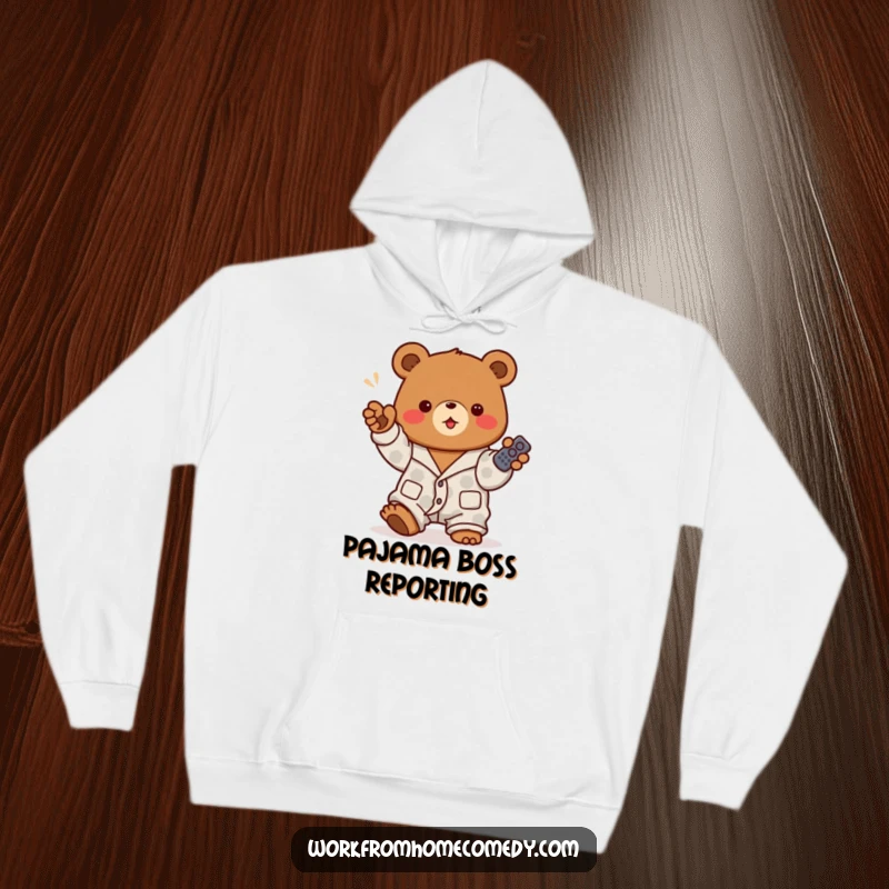 Funny brown bear dressed in pajamas, enthusiastically holding a remote control on a hoodie, perfect for ultimate relaxation and binge-watching.